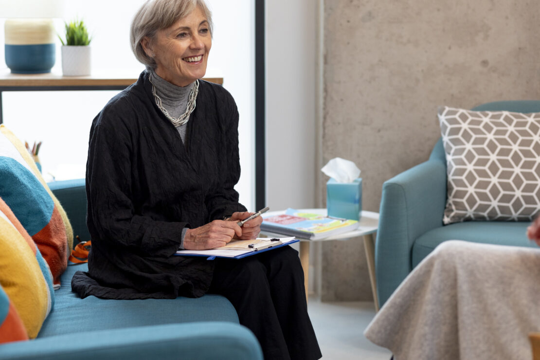clinician in consultation chair with notebook, thorough/attentive tone